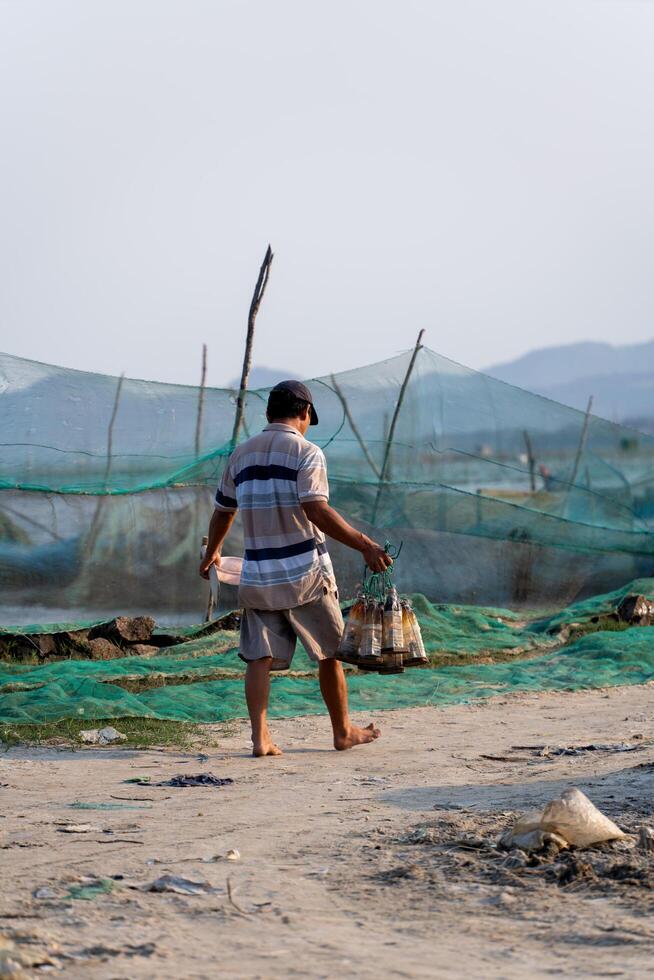 Traditional fishermen and boats in O Loan lagoon during sunset, Phu Yen province, Vietnam. Travel and landscape concept photo