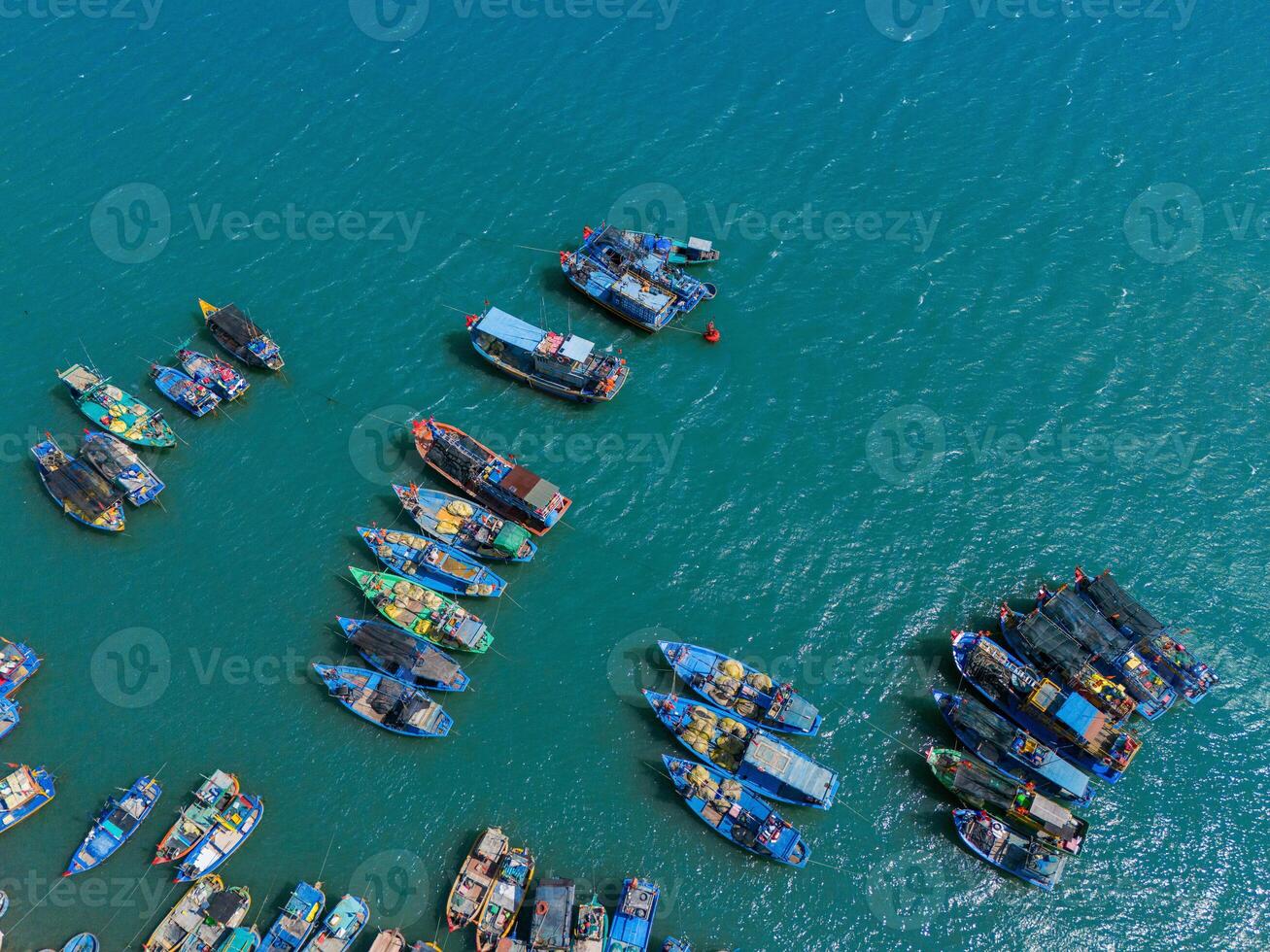 Aerial view of Loc An fishing village, Vung Tau city. A fishing port with tsunami protection concrete blocks. Cityscape and traditional boats in the sea. photo