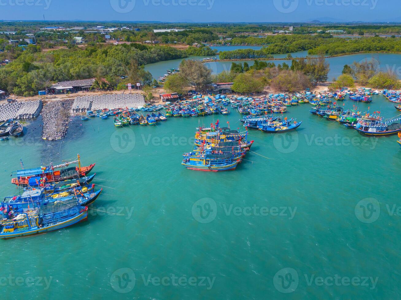 Aerial view of Loc An fishing village, Vung Tau city. A fishing port with tsunami protection concrete blocks. Cityscape and traditional boats in the sea. photo