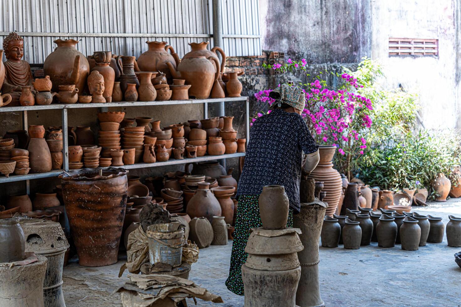a pottery artist create traditional handicraft clay vase in Bau Truc pottery village. Using traditional techniques. photo
