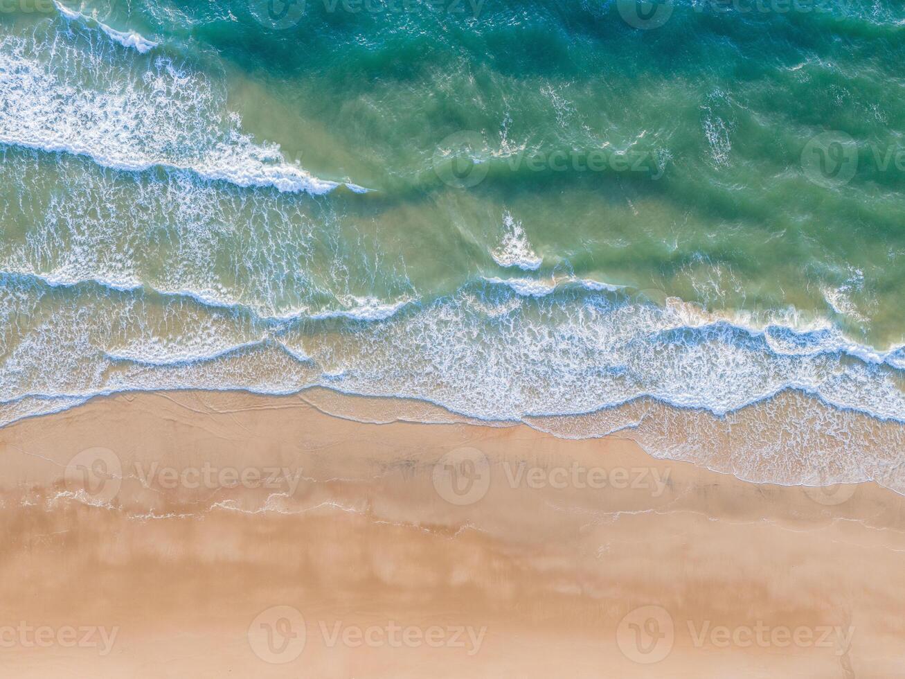 Ocean waves on the beach as a background. Aerial top down view of beach and sea with blue water waves. Vietnam beach photo
