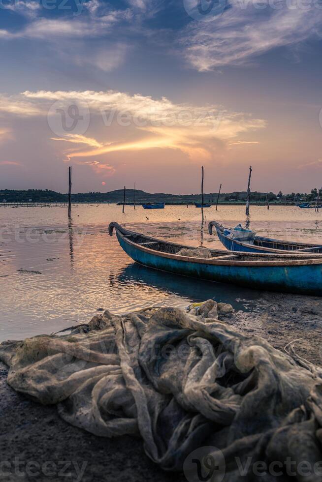 Traditional boats in O Loan lagoon during sunset, Phu Yen province, Vietnam. Travel and landscape concept photo