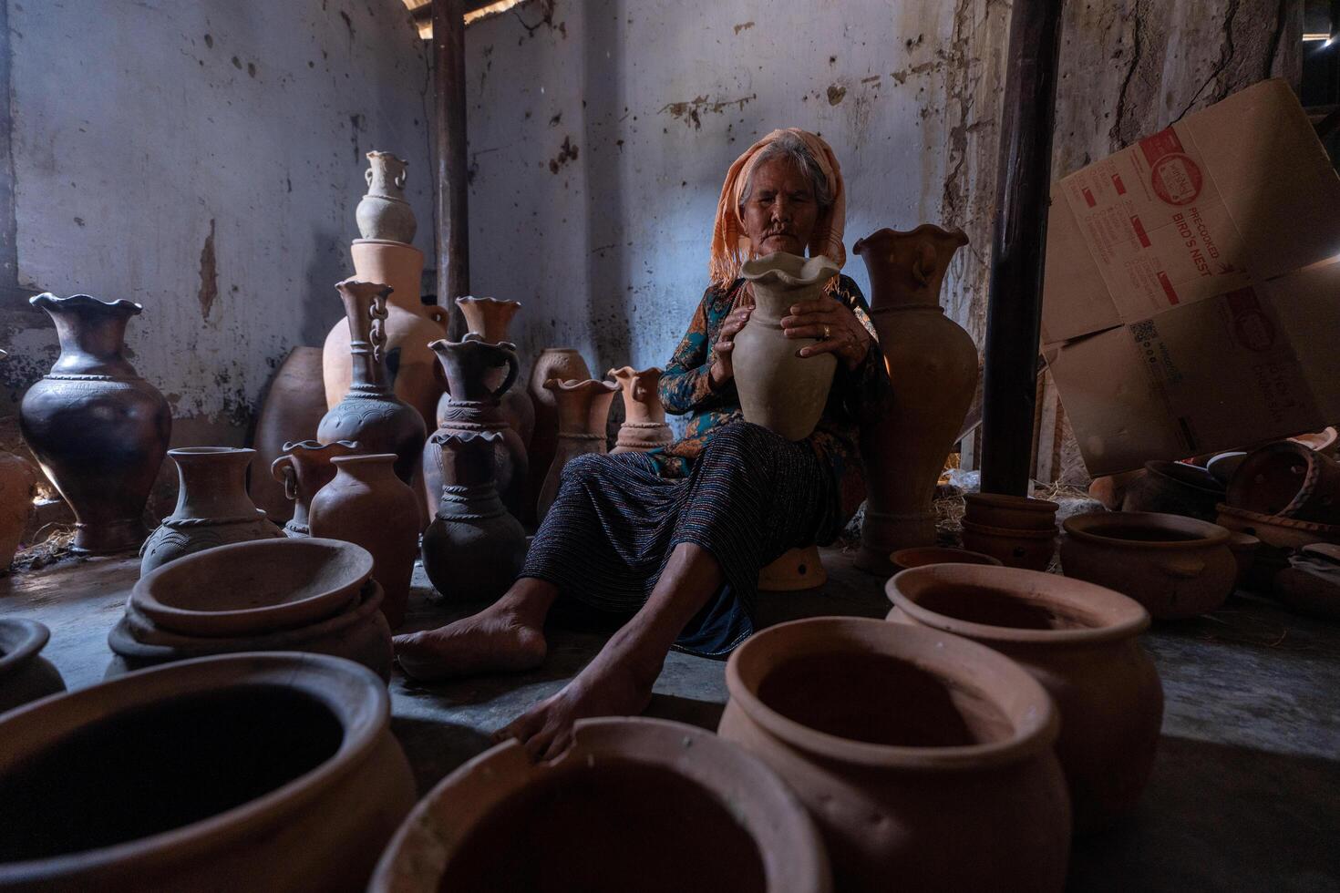 old female of Cham ethnic girl in Bau Truc pottery village, Phan Rang city, Ninh Thuan province, Vietnam. People and travel concept. photo
