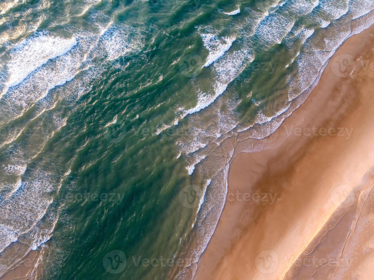 Ocean waves on the beach as a background. Aerial top down view of beach and sea with blue water waves. Vietnam beach photo