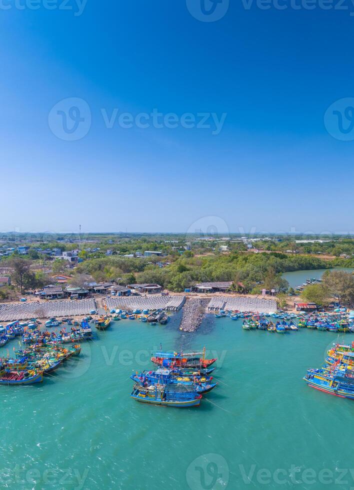 Aerial view of Loc An fishing village, Vung Tau city. A fishing port with tsunami protection concrete blocks. Cityscape and traditional boats in the sea. photo