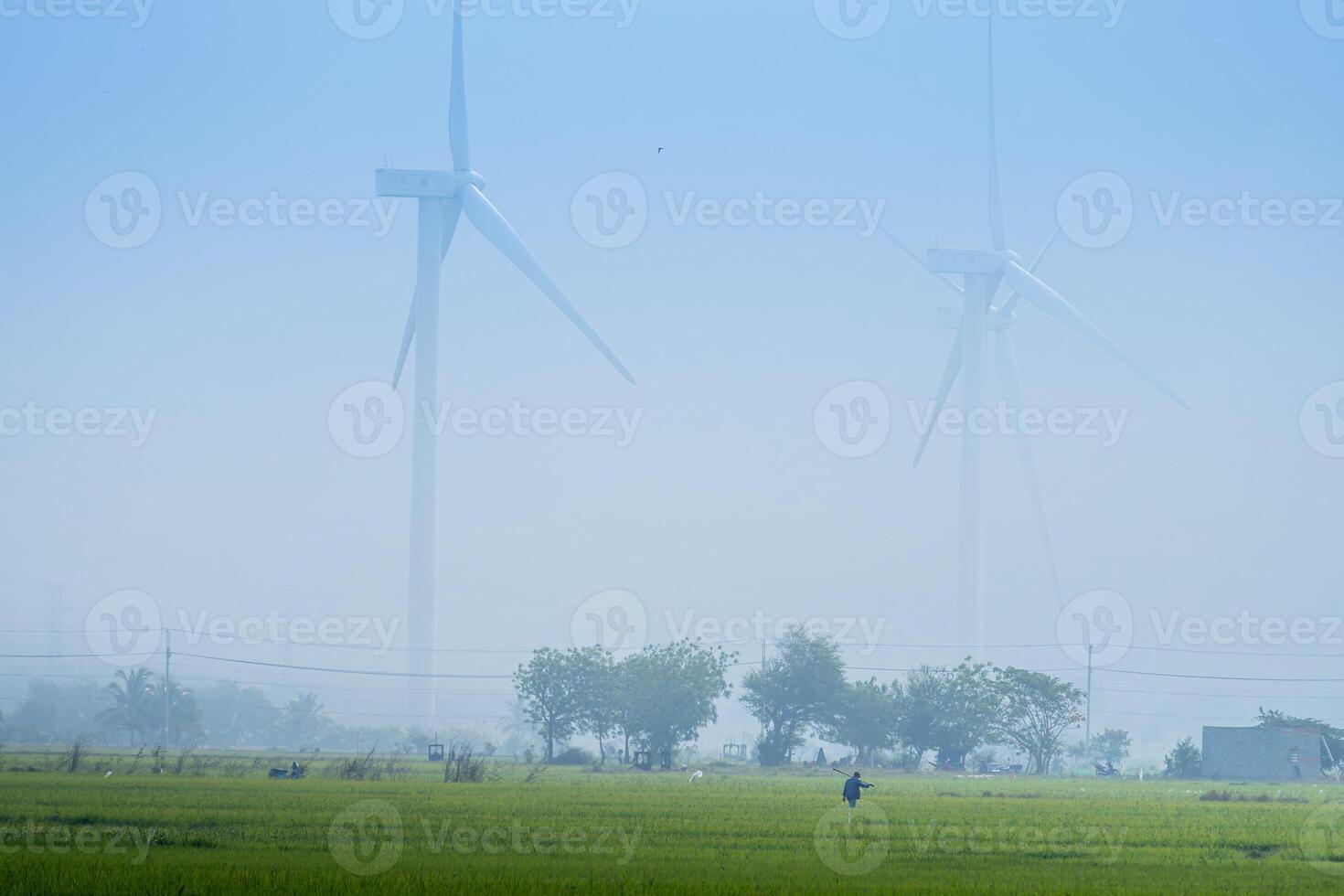 view of turbine green energy electricity, windmill for electric power production, Wind turbines generating electricity on rice field at Phan Rang, Ninh Thuan province, Vietnam photo