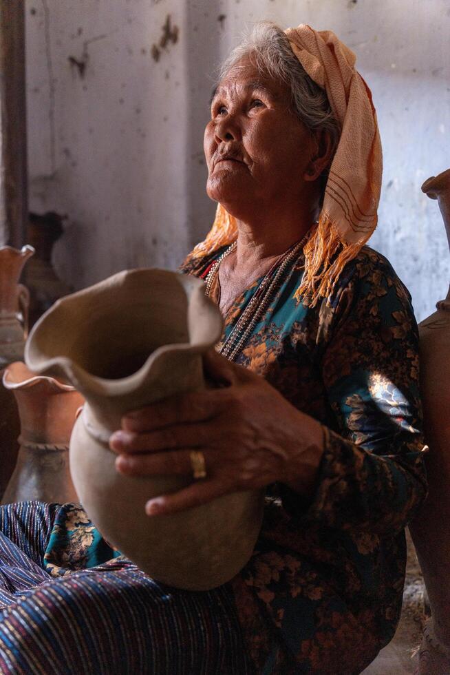 old female of Cham ethnic girl in Bau Truc pottery village, Phan Rang city, Ninh Thuan province, Vietnam. People and travel concept. photo