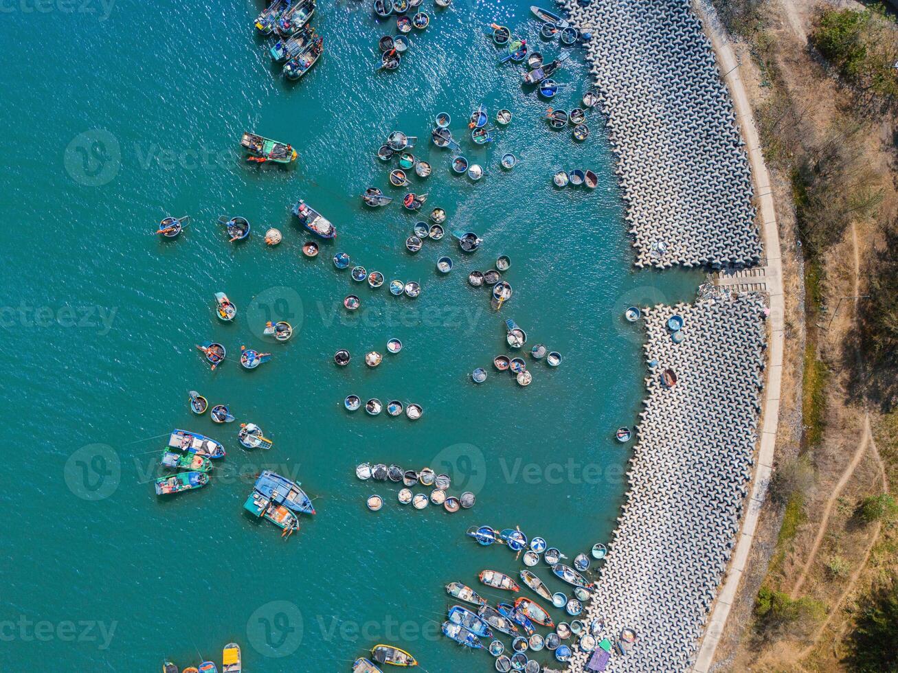 Aerial view of Loc An fishing village, Vung Tau city. A fishing port with tsunami protection concrete blocks. Cityscape and traditional boats in the sea. photo