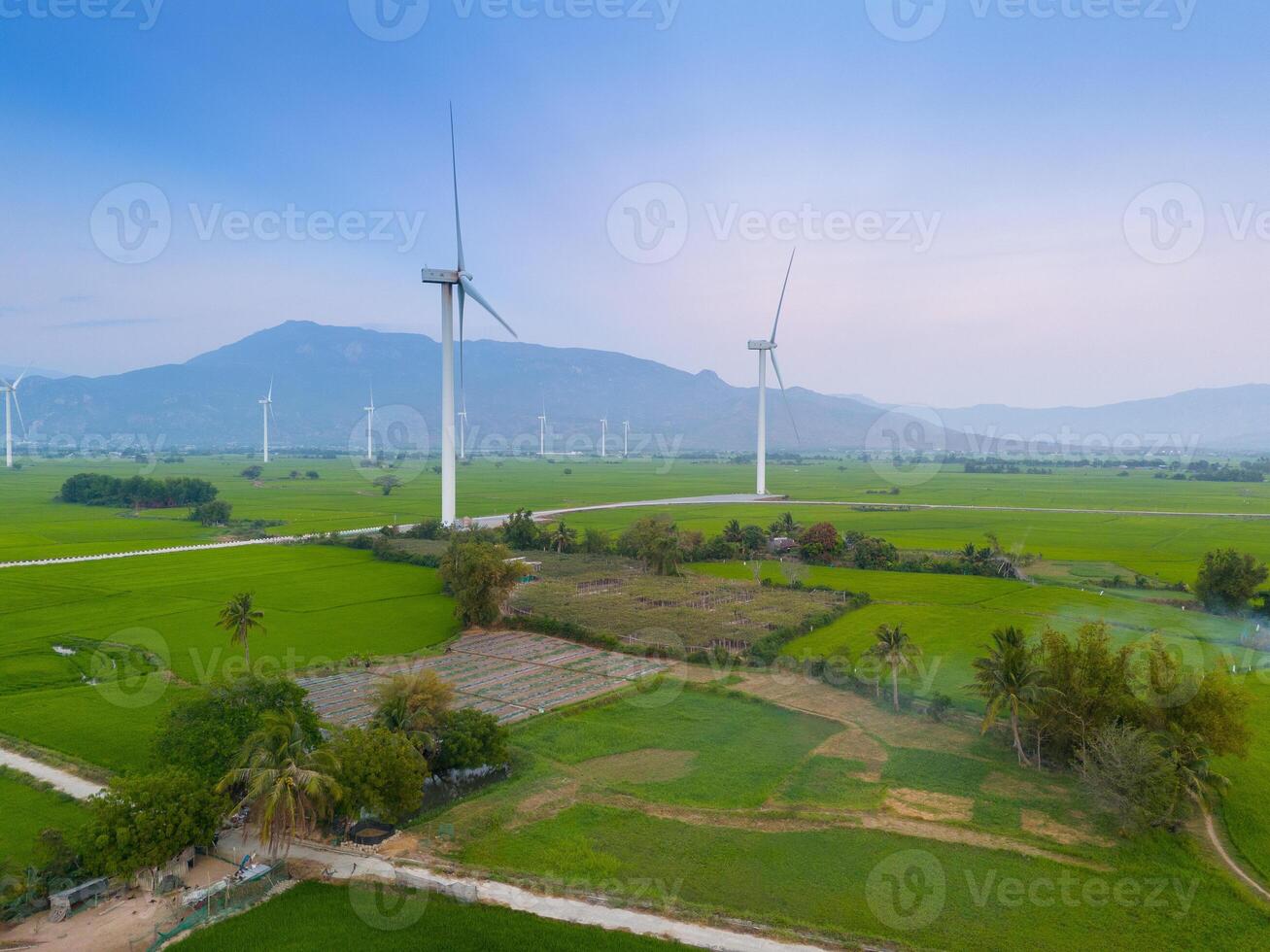 view of turbine green energy electricity, windmill for electric power production, Wind turbines generating electricity on rice field at Phan Rang, Ninh Thuan province, Vietnam photo