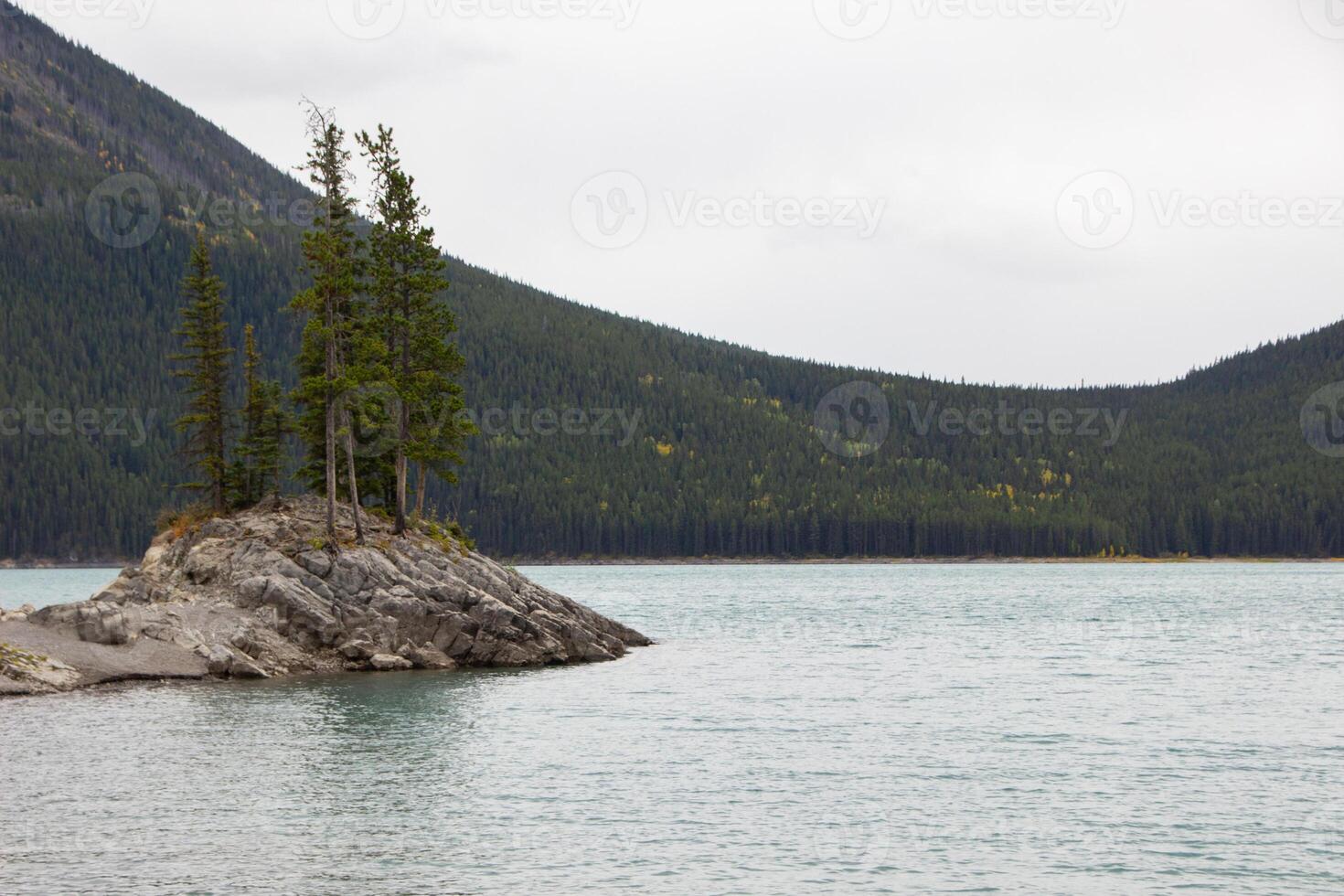 Cloudy Day on Rocky Island in Lake Minnewanka, Canadian Rocky Mountains, Banff National Park photo