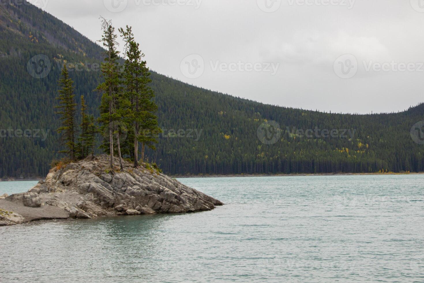 Cloudy Day on Rocky Island in Lake Minnewanka, Canadian Rocky Mountains, Banff National Park photo