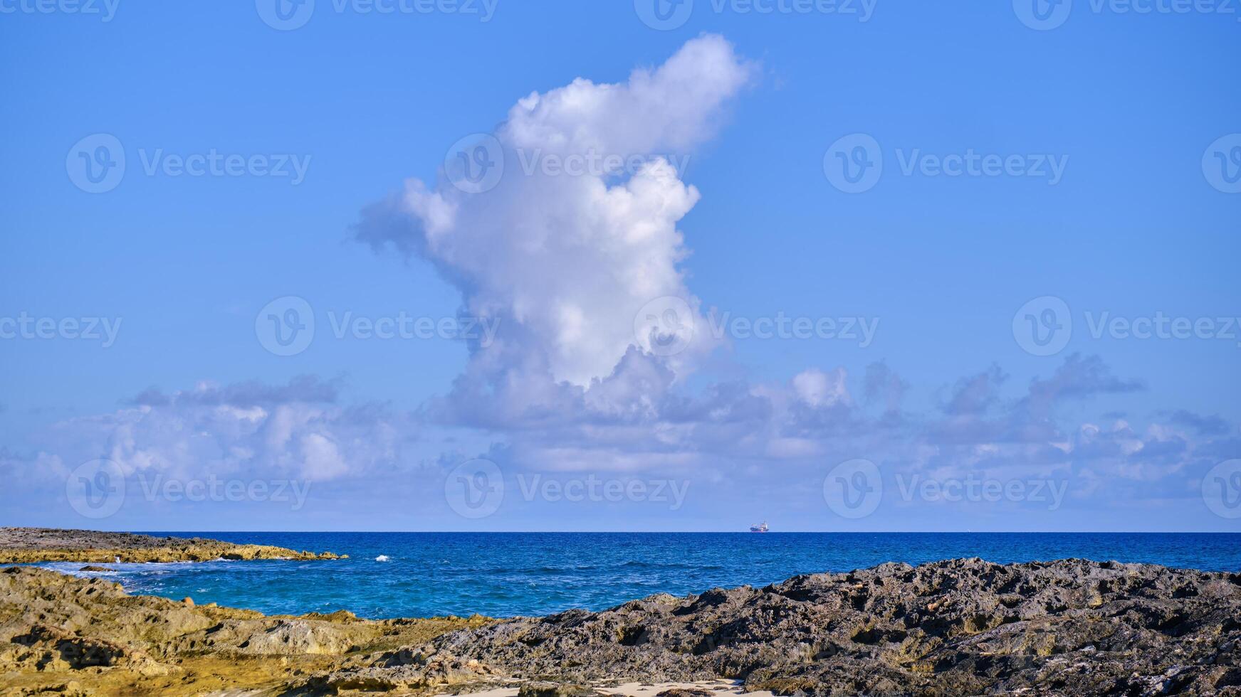 Tall cloud over the Atlantic Ocean on a partly cloudy morning in the Bahamas photo
