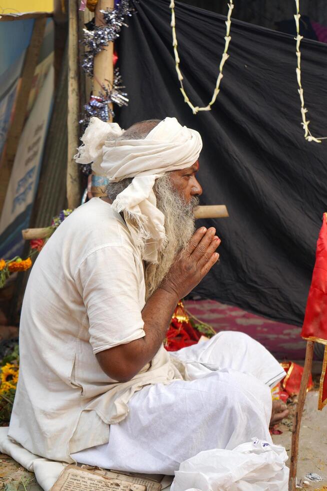 15th January 2023, Kolkata, West Bengal, India. Portrait of Indian Sadhu praying at Kolkata Ganga Sagar Transit Camp photo