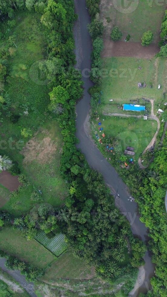 Aerial view of a small river in the middle of the jungle photo