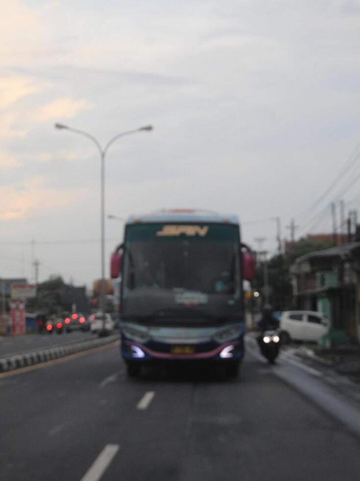 defocused abstract background of bus on the highway at semarang, Indonesia April 16 2024 photo