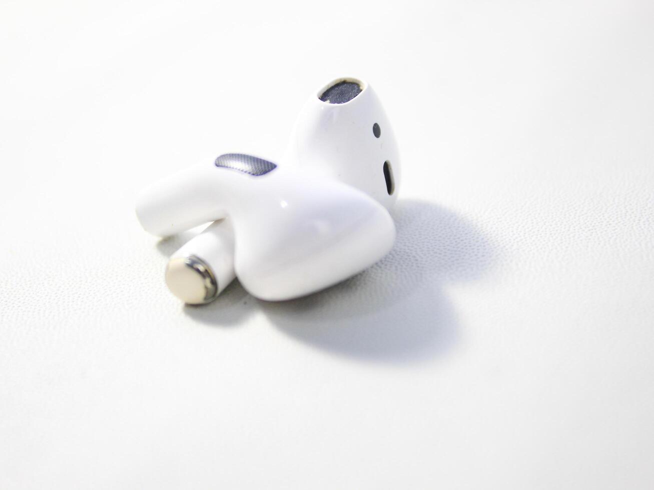 Closeup white TWS true wireless stereo earbuds in case isolated on white background. photo