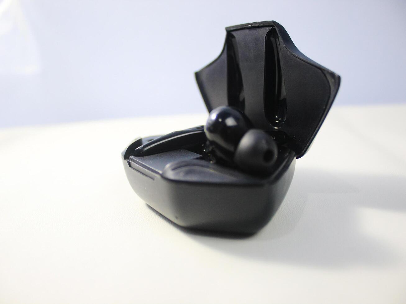 Charging dock with TWS bluetooth headset or earbuds on white background photo