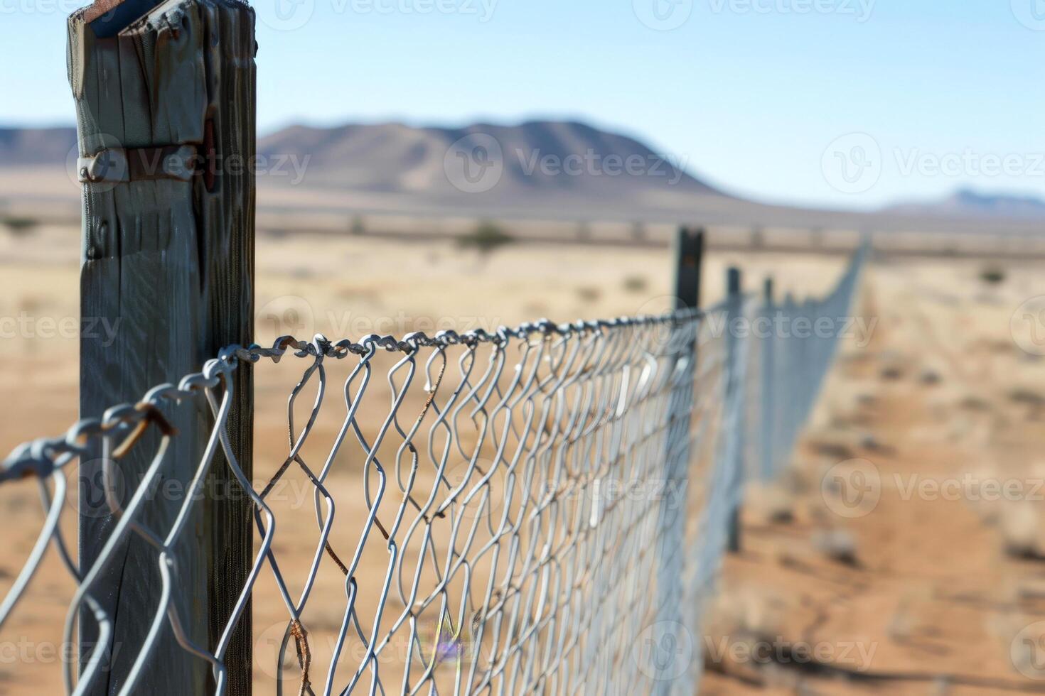 A closeup of the barbed wire on top of an outdoor fence symbolizing security and protection photo