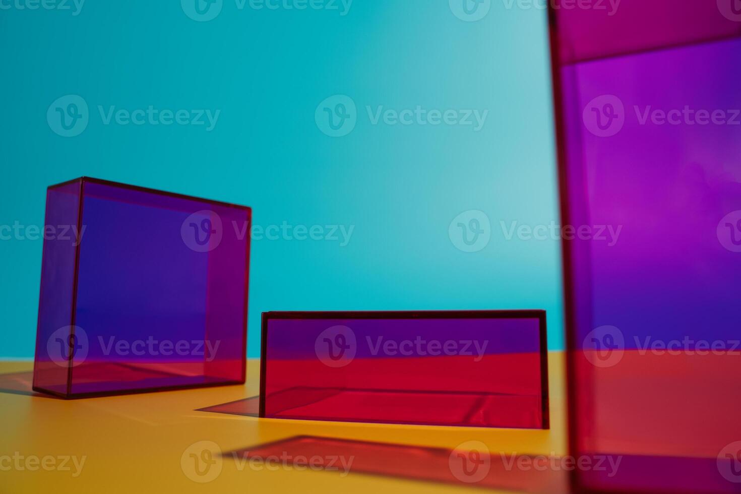 three colorful boxes are sitting on a yellow table photo