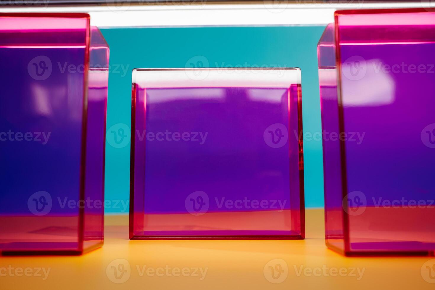 three colorful boxes are sitting on a yellow table photo