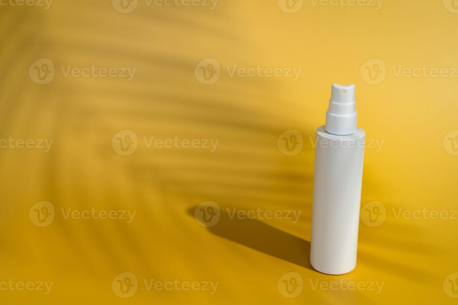 Blank white spray bottle with palm tree shadow photo