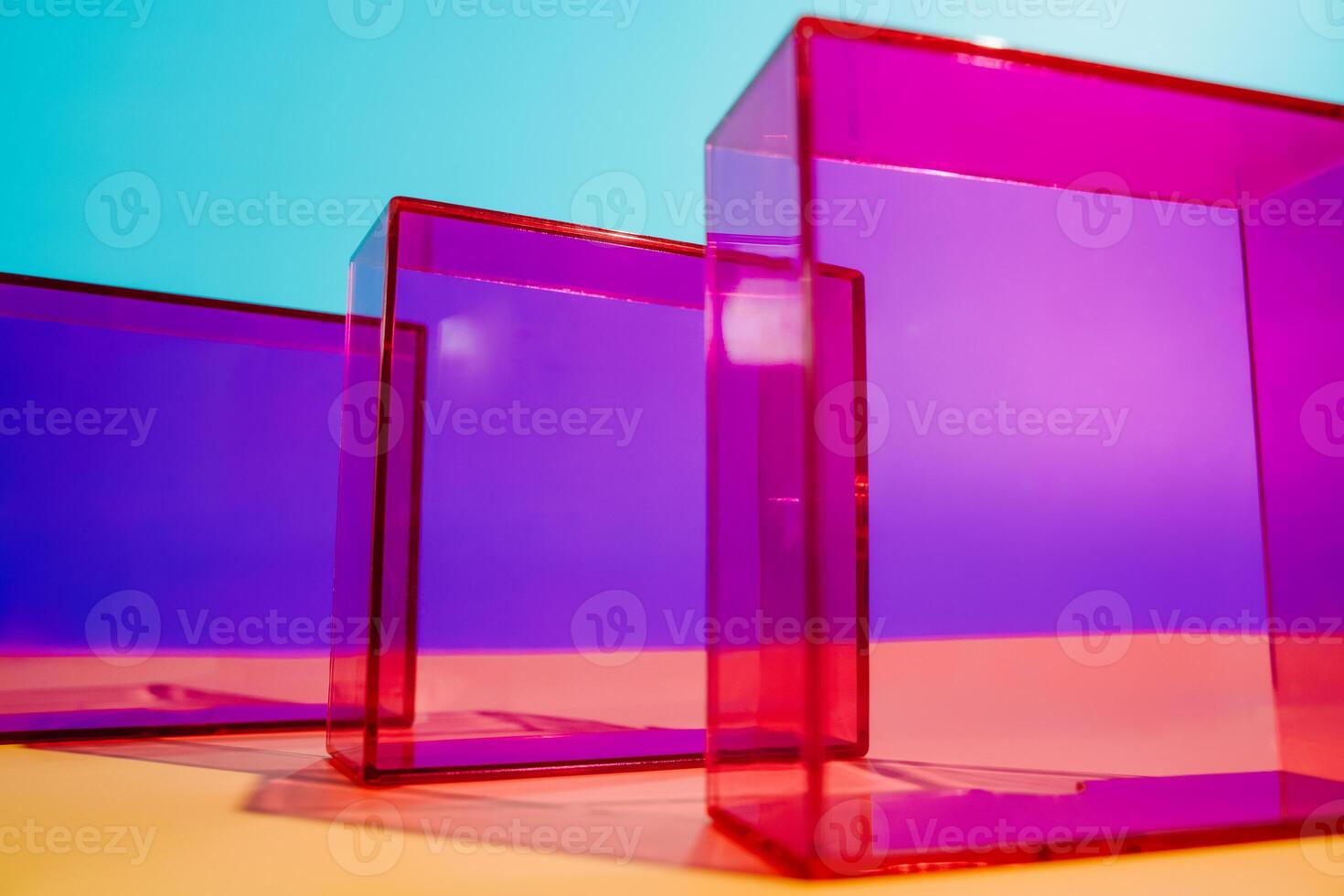 three colorful boxes are sitting on a yellow table photo