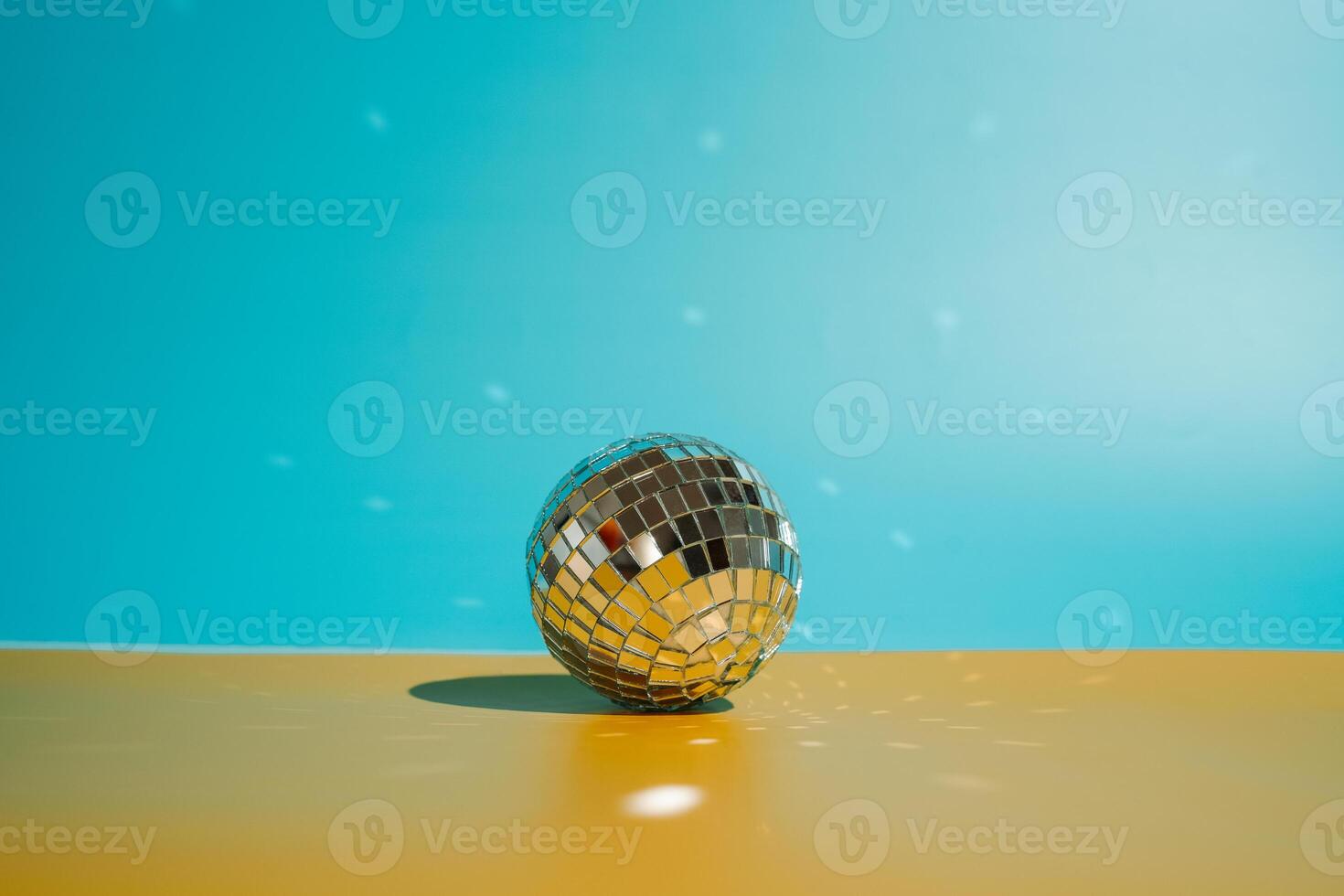 disco ball on yellow and blue background photo
