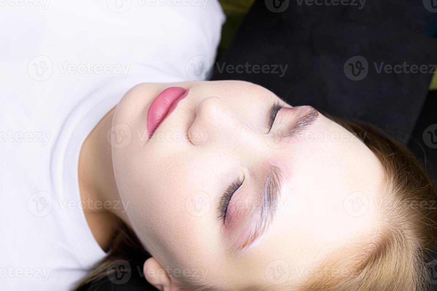 a close-up model of the eyebrow lamination procedure has laminating compositions applied to the eyebrows photo