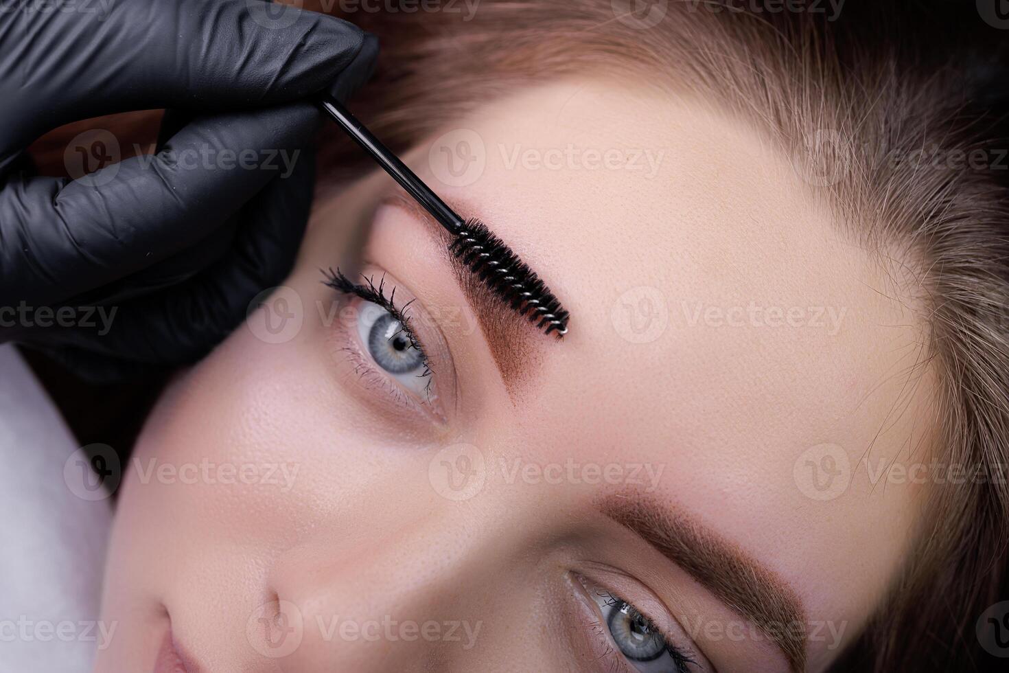 Eyebrows of a young girl after permanent eyebrow makeup procedure. PMU Procedure, Permanent Eyebrow Makeup. photo