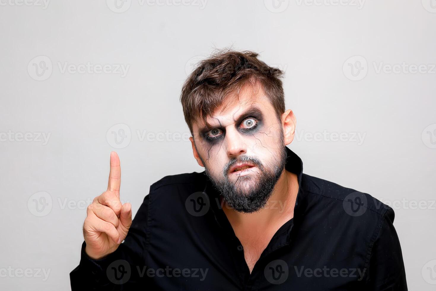 halloween makeup bearded man posing on camera photo