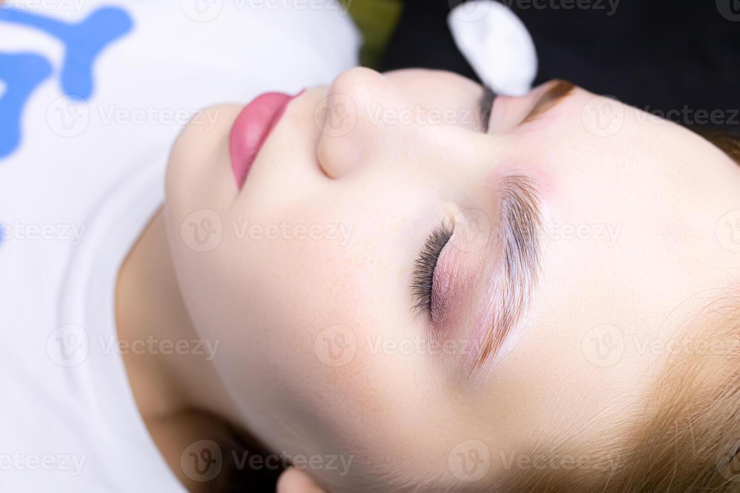 a close-up model of the eyebrow lamination procedure has laminating compositions applied to the eyebrows photo