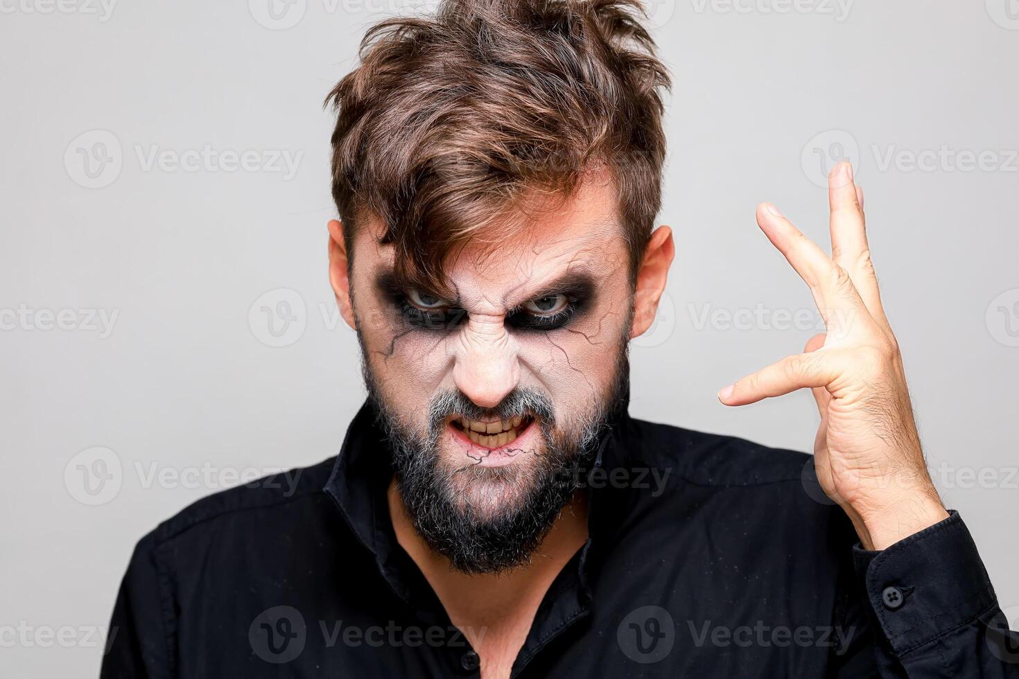 The frightening look of a bearded man with undead-style makeup for Halloween photo