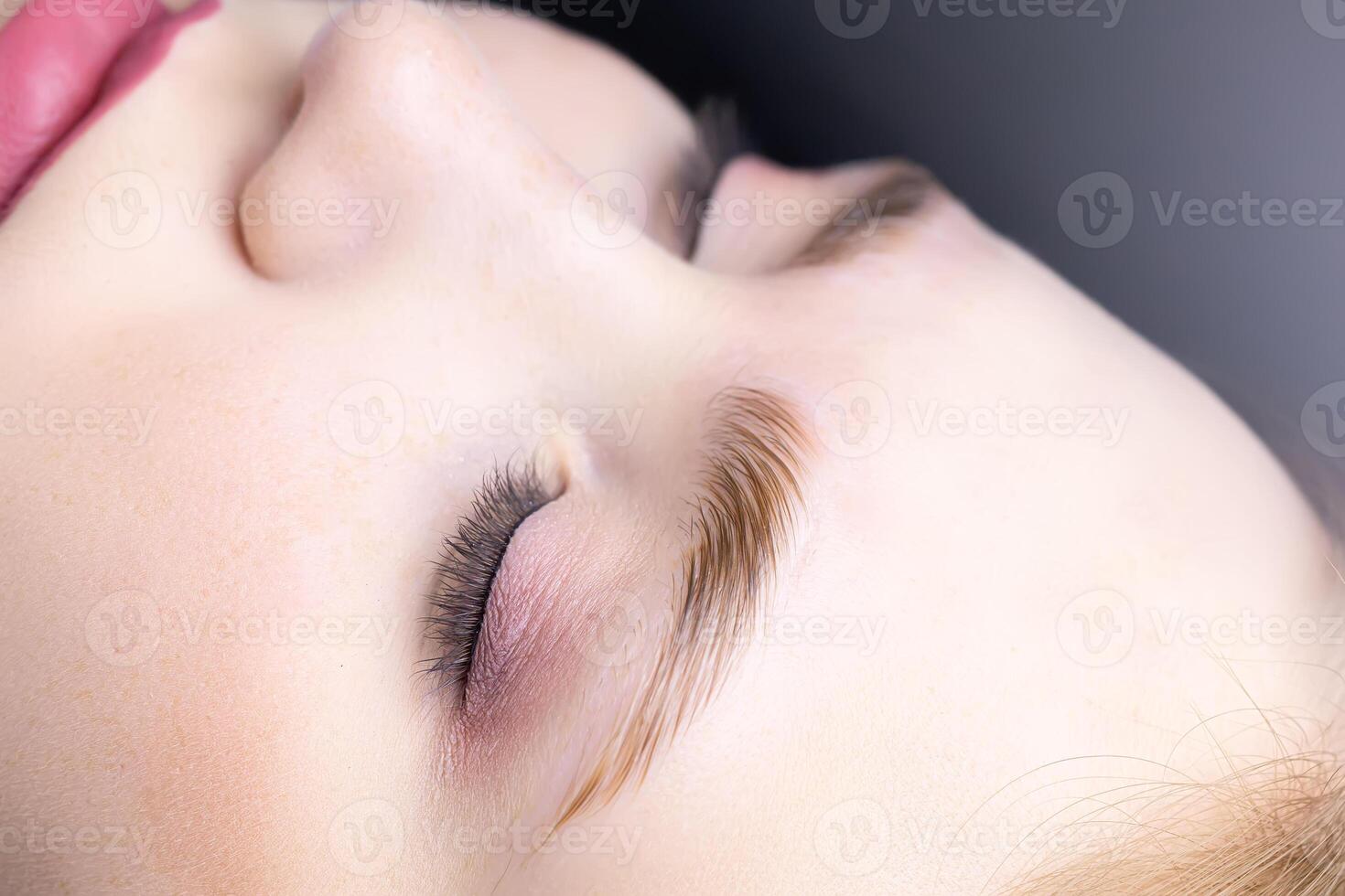 close-up of the model's combed eyebrows with the help of laminating compositions photo