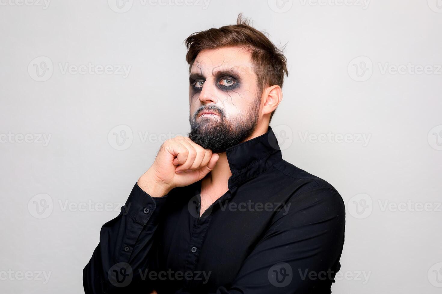 halloween makeup bearded man posing on camera photo