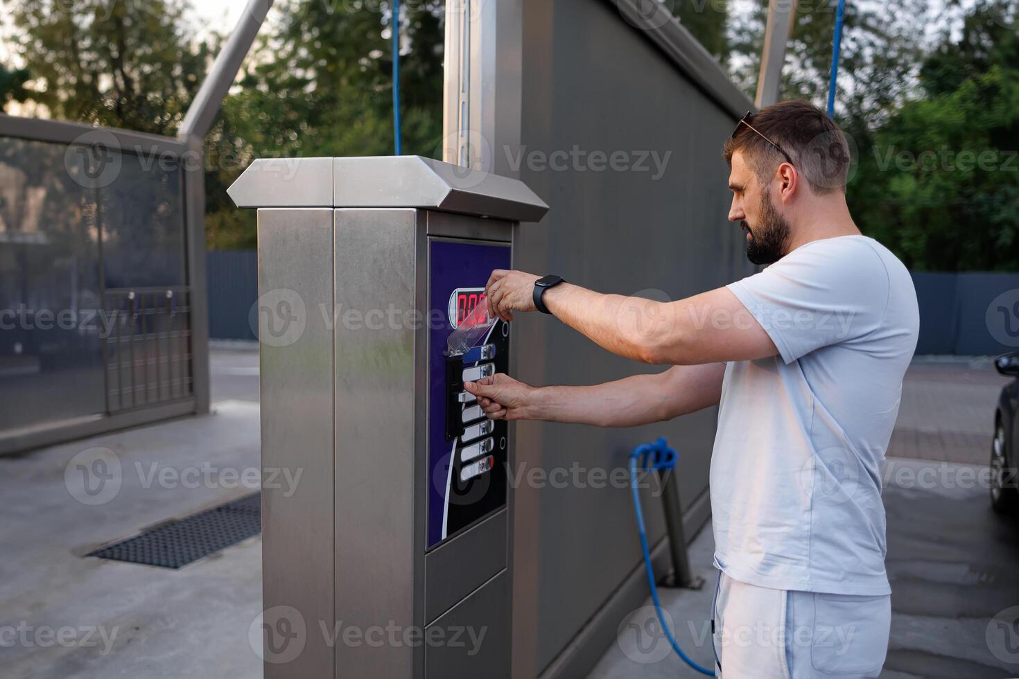 A person pays to have their car washed. A car at a self service car wash. photo