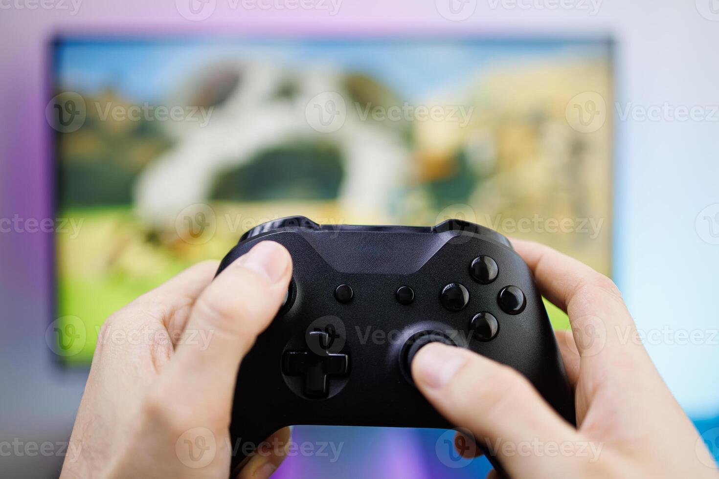 Pressing the sticks of a game gamepad in front of the monitor. game gamepad in hand photo