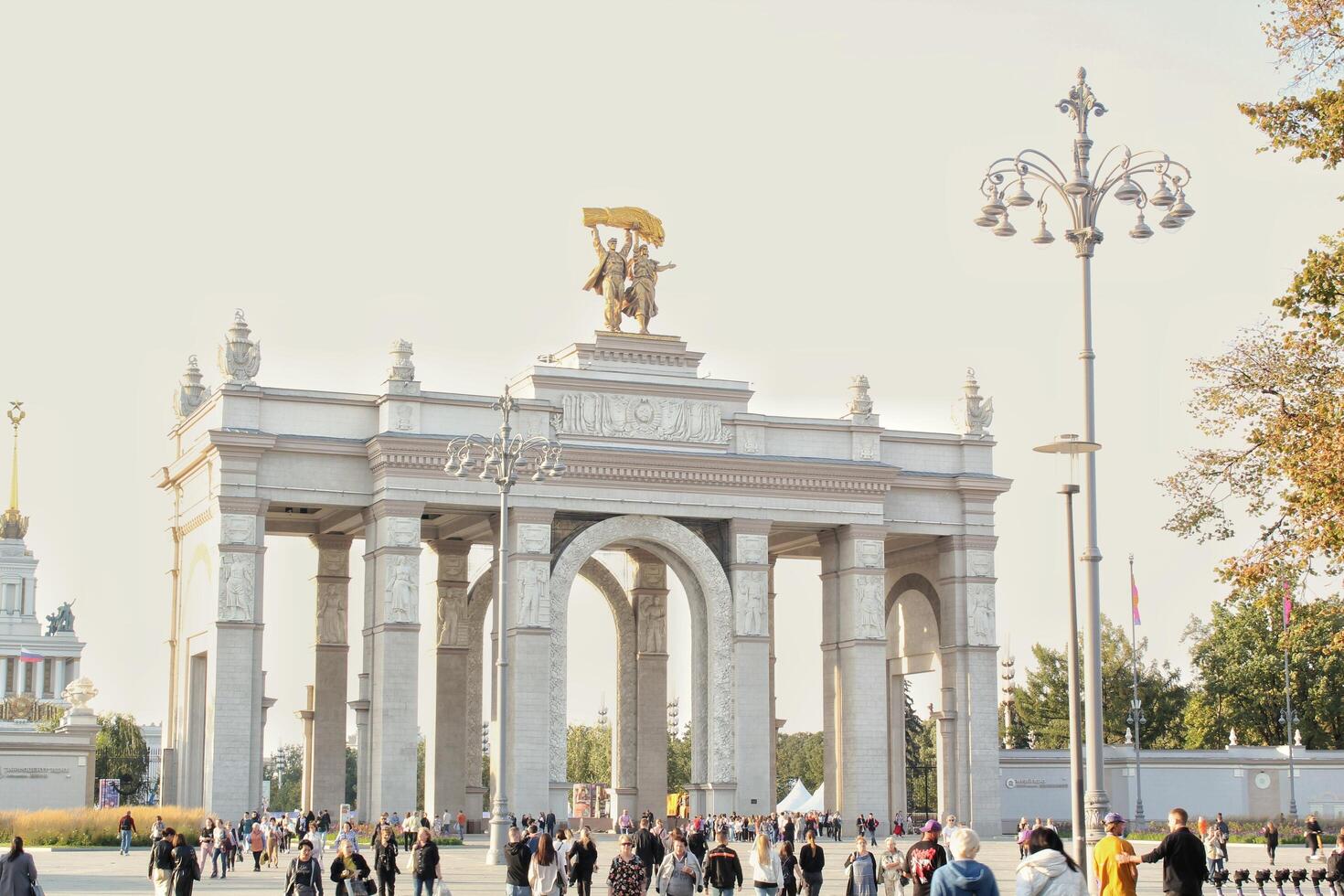 Main entrance to VDNH. Moscow Exhibition of Achievements. Main triumphal architecture arch of the central entrance of VDNKH. Moscow, Russia - September 20, 2023 photo