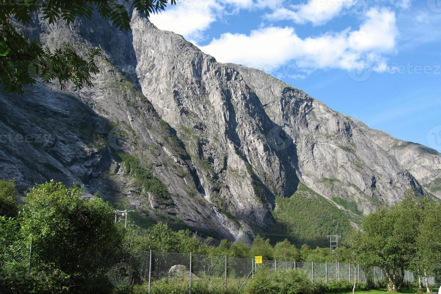 The Troll Wall Trollveggen mountain massif Trolltindene Troll Peaks in the Romsdalen valley, Norway. Rauma railway through Romsdalen Valley, Andalsnes, Norway photo