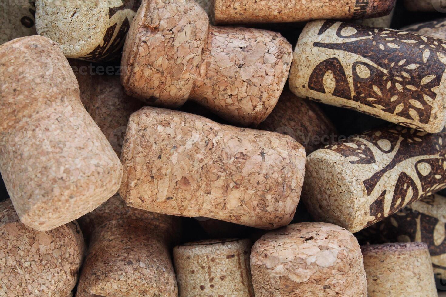 Pile of natural wooden wine corks close up as background. Concept of environmental protection and waste separation. Recycled closures used for sealing wine bottles photo