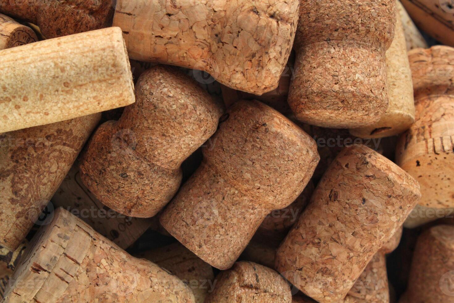 Pile of natural wooden wine corks close up as background. Concept of environmental protection and waste separation. Recycled closures used for sealing wine bottles photo