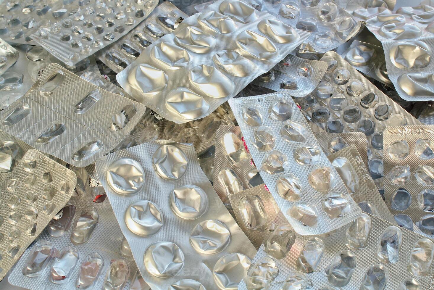 Pile of empty pill blister packs. Treatment and medication concept. Empty blister packages for recycling. Separate garbage sorting. Close up of clinical waste. Reducing medical waste disposal photo