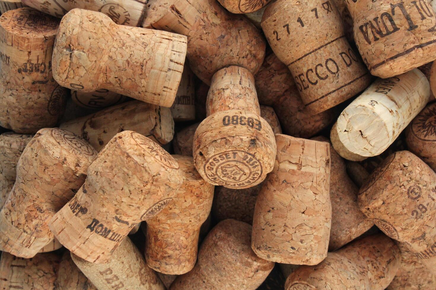 Pile of natural wooden wine corks close up as background. Concept of environmental protection and waste separation. Recycled closures used for sealing wine bottles. Moscow, Russia - January 05, 2024 photo