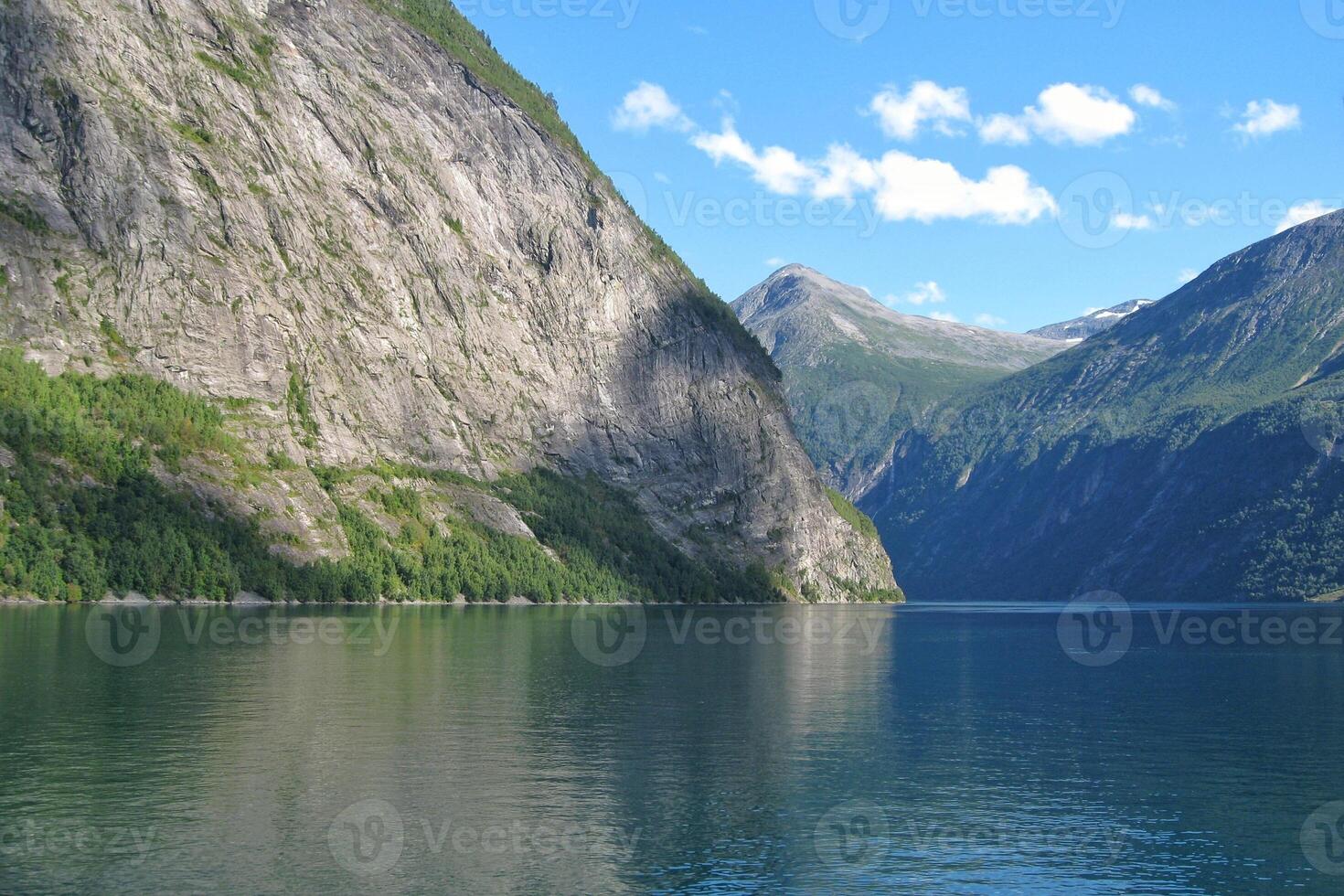 View of Geiranger fjord from the boat, Western fjords, Norway. Hardanger fjord landscape. Scandinavian mountains of Sunnylvsfjorden canyon photo