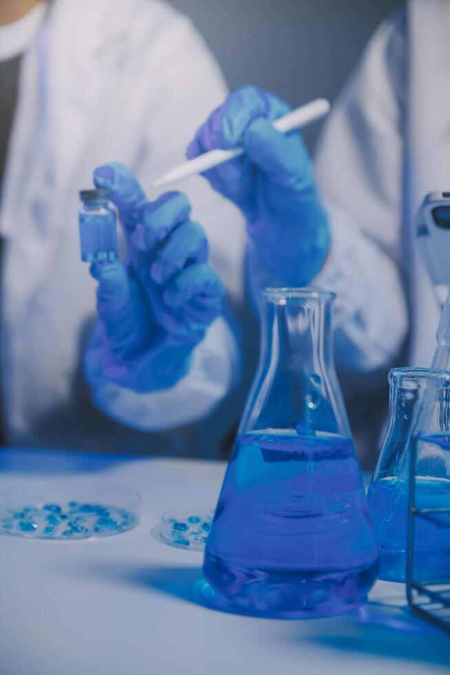 chemist,scientist hand dropping chemical liquid into test tube, science research and development concept photo