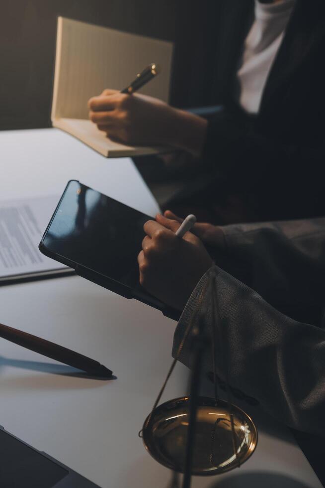 Lawyer, legal advisor, businessman brainstorming information on agreement details Business contracts in legal processing books for accuracy in contract documents. joint financial investment. photo