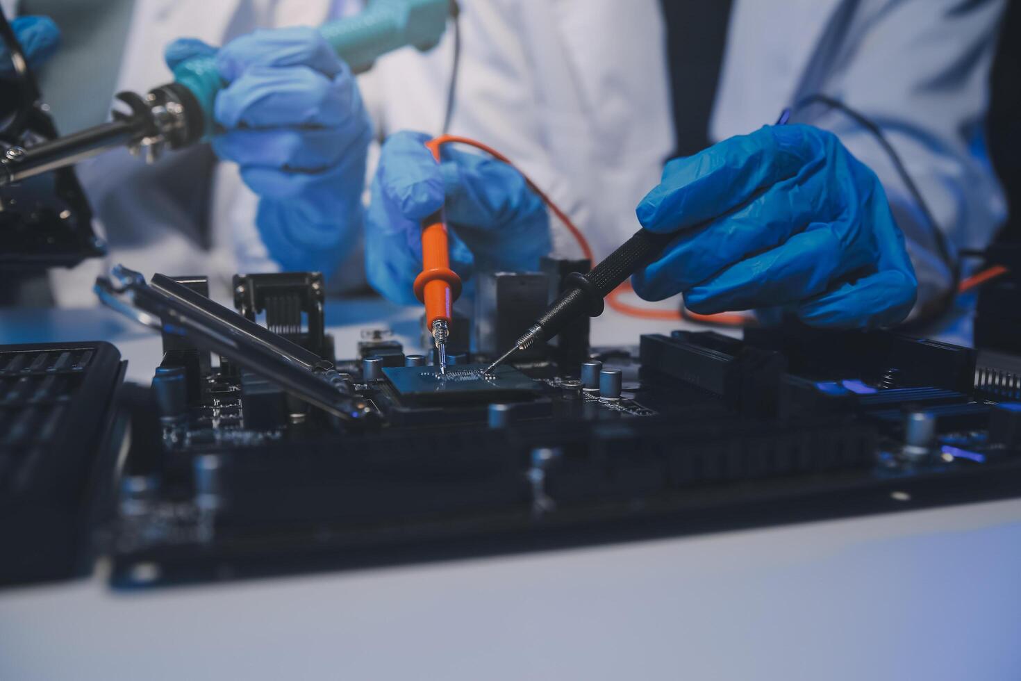 Close up of Technician measuring voltage electronic circuit board television, Service after sale fix electric equipment within insurance. photo