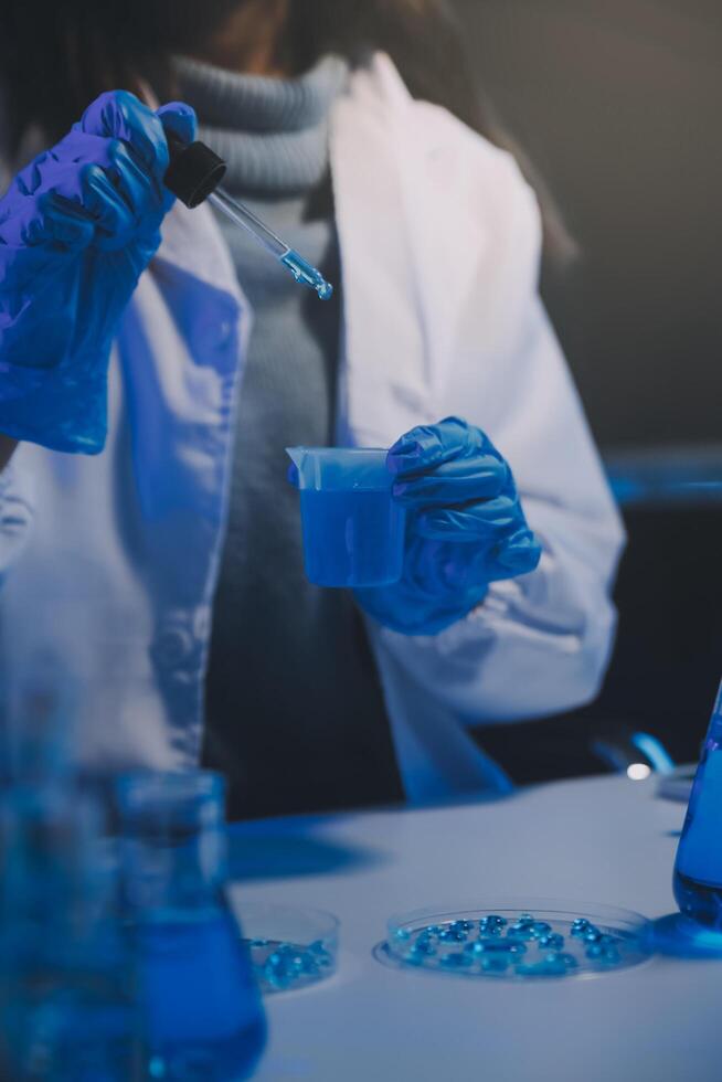 chemist,scientist hand dropping chemical liquid into test tube, science research and development concept photo