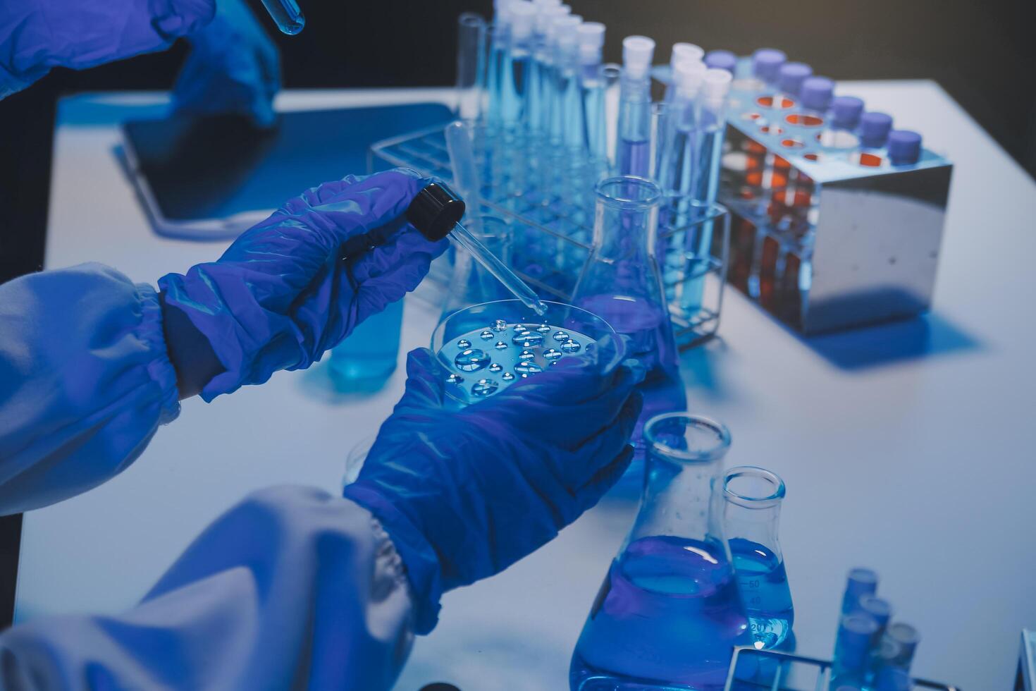 chemist,scientist hand dropping chemical liquid into test tube, science research and development concept photo