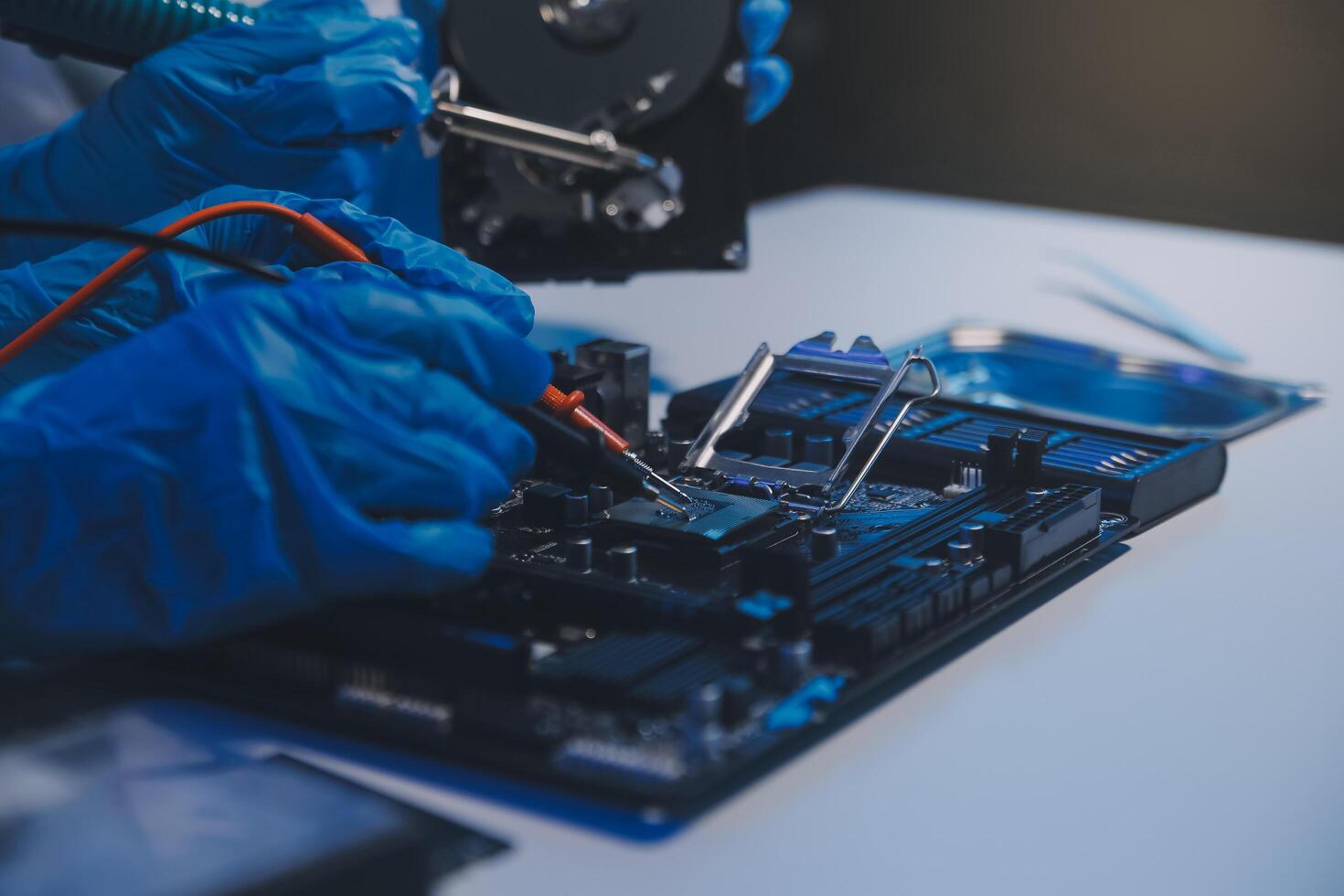 Close up of Technician measuring voltage electronic circuit board television, Service after sale fix electric equipment within insurance. photo