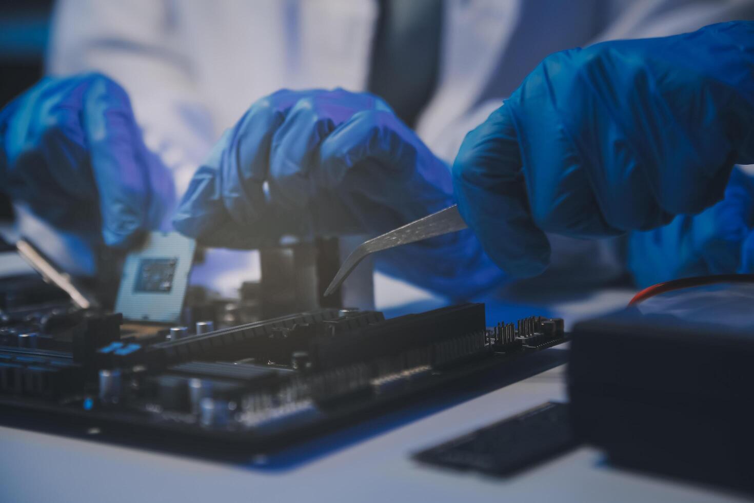 Close up of Technician measuring voltage electronic circuit board television, Service after sale fix electric equipment within insurance. photo